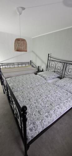 a bedroom with a black bed with a white comforter at Hochwald appartement in Bad Sachsa