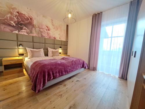 a bedroom with a bed and a painting on the wall at B&B Brunnerhof in Feldthurns