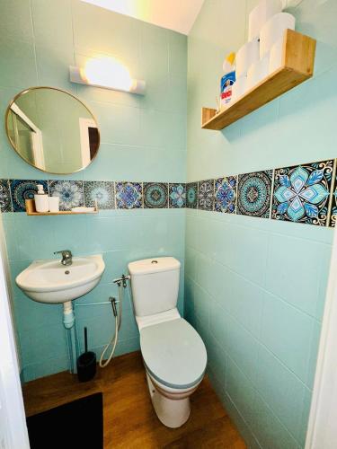 a bathroom with a toilet and a sink at petit studio de bourgogne in Saint-Albain