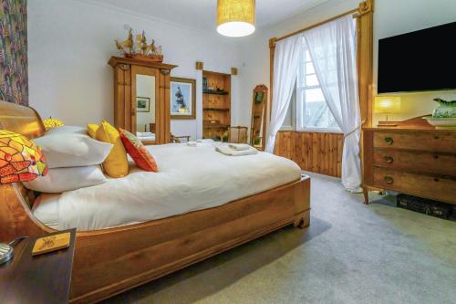 a large bedroom with a large bed and a dresser at 4 Bed in Pittenweem oc-t35090 in Pittenweem