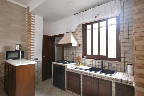 a kitchen with a sink and a window at Free Parking - Maria House in Torre del Greco