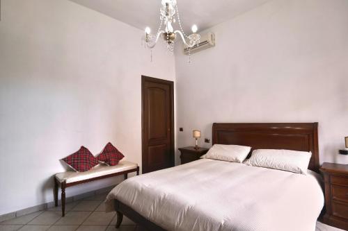 a bedroom with a bed and a chandelier at Free Parking - Maria House in Torre del Greco