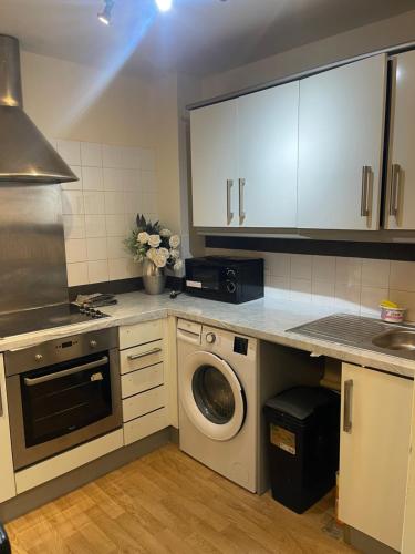 a kitchen with a washing machine and a dishwasher at Casa Centro two bedroom apartment in Wolverhampton