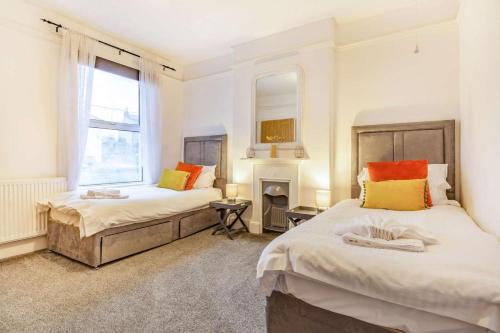 a bedroom with two beds and a fireplace at 4 Bed in St. Austell oc-t32965 in St Austell