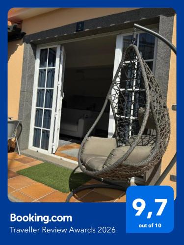 a wicker chair sitting in front of a house at Alforra Residence 2-Centro-Praias-Levadas in Câmara de Lobos