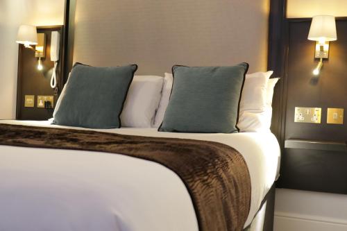a bedroom with a bed with two pillows at Arran House Hotel in London