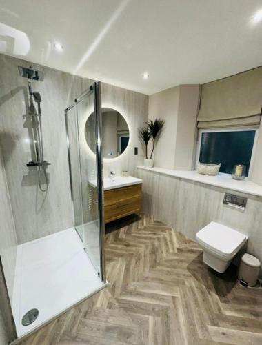 a bathroom with a shower and a toilet and a sink at HORSEMARKET on the square in Kelso