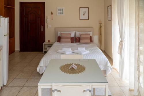 a bedroom with a large bed and a table at Stergios_Apartments 05 in Kozani