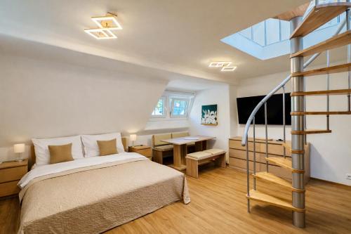 a bedroom with a bed and a spiral staircase at Apartmány Ella in Hřensko