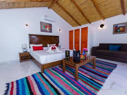 a bedroom with a bed and a table and a couch at Maison ALPHEA SPA HAMMAM in Marrakesh