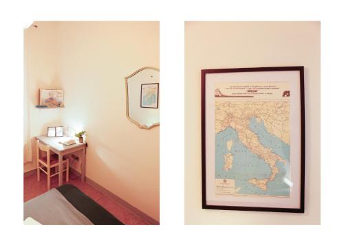 a picture of a room with a map and a mirror at Casa Pepe in Pisa
