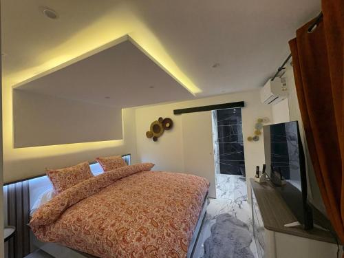 a bedroom with a large bed and a bathroom at Melrose Loft with master suite in Sanary-sur-Mer