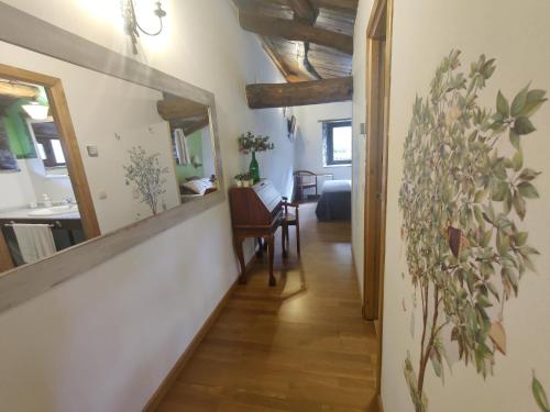 a hallway with a mirror and a desk in a room at O Muiño de Pena in O Pino 