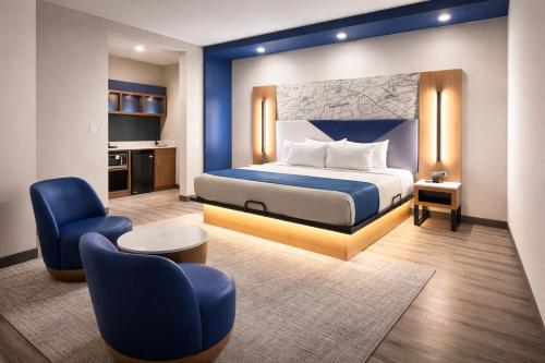 a hotel room with a bed and a chair at Crystal Inn - NorthWest - 290 in Houston