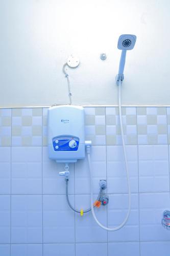 a shower in a tiled bathroom with a shower at Hakyiri B&B in Kabale