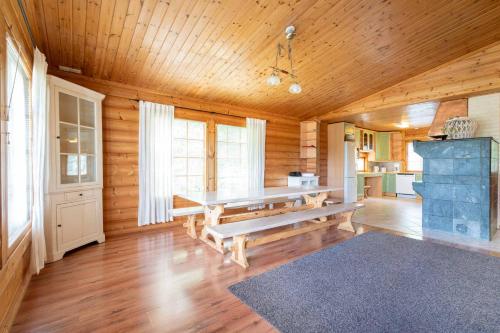 a wooden room with a bench and a kitchen at Himospeili in Jämsä