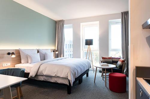 a hotel room with a bed and a window at sylc. Apartmenthotel – Serviced Apartments in Hamburg