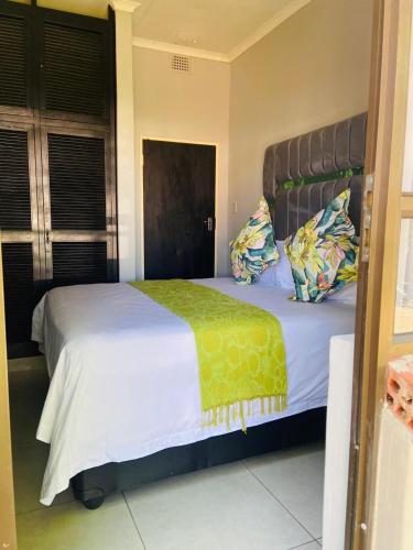 a bedroom with a large bed with white sheets and pillows at The Rehoboth in Dundee