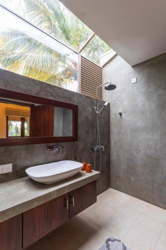 a bathroom with a sink and a shower at ONA Garden Villa in Galle