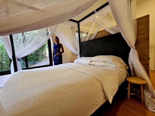 a bedroom with a large bed with a canopy at MaraRiver TreeHouse in Musiara Campsite