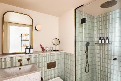a bathroom with a shower and a sink at Hotel Indigo London K West Shepherd's Bush by IHG in London