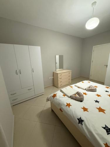 a bedroom with a bed with stars on it at Ferit's Property Near Astir in Tirana