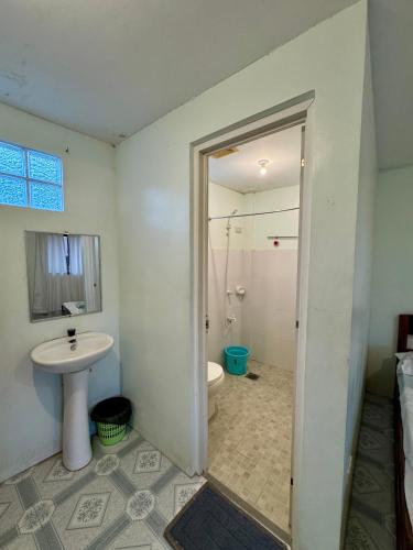 a bathroom with a sink and a toilet at Juban Guest House in Pooc