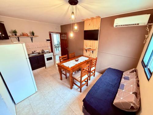a living room with a table and a kitchen at Tucuman 890 in Villa María