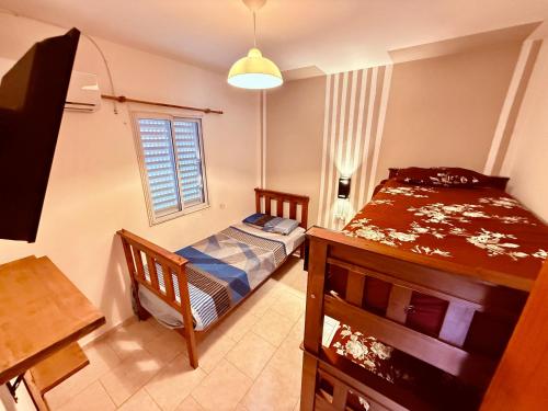 a small bedroom with a bed and a window at Tucuman 890 in Villa María
