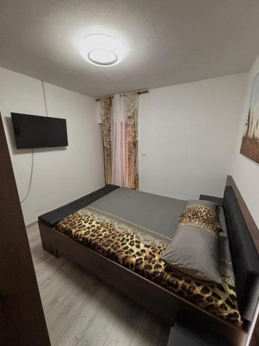 a bedroom with a bed with a leopard print mattress at Tina in Privlaka