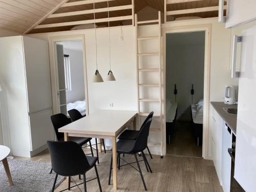 a dining room and kitchen with a table and chairs at Rosenvold Strand Camping in Stouby