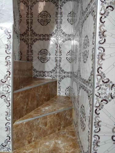 a walk in shower in a room with tiles at Taghazout Beachside Haven Ocean View Apartment in Taghazout
