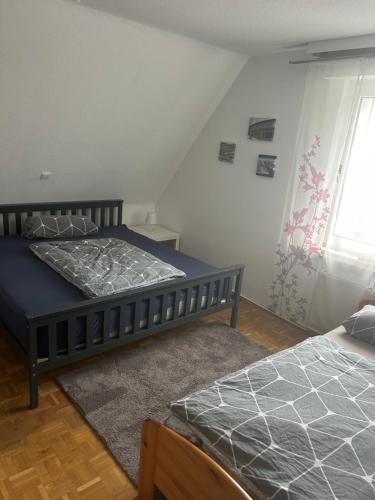 a bedroom with two beds and a window at Ferienwohnung Kierspe in Kierspe