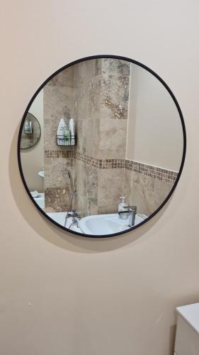 a mirror on a bathroom wall with a sink at PR 2 BR Modern Home in Middlesbrough