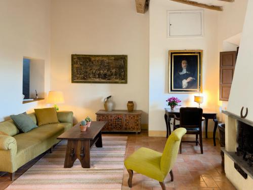 a living room with a couch and a table at Tuscan Farmhouses at Castello del Calcione Estate in Lucignano