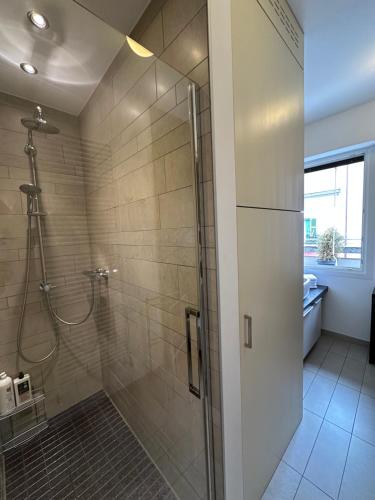 a bathroom with a shower with a glass door at Civico6 in Tirano