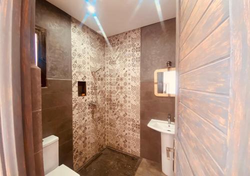 a bathroom with a toilet and a sink at Dar Ayman Essaouira in Essaouira