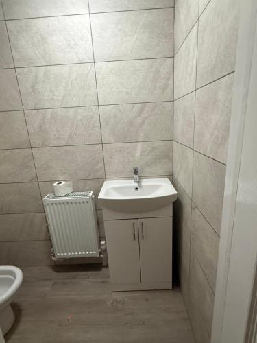 a bathroom with a sink and a toilet at Pear Barn Haven in Wisbech Saint Mary