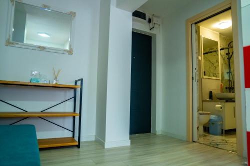 a room with a bathroom with a toilet and a mirror at Studio Vata in Vaţa de Jos