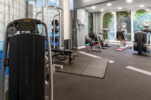 a gym with treadmills and machines in a room at Royal Bath Hotel Bournemouth in Bournemouth