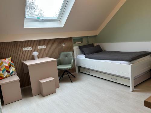 a small bedroom with a bed and a chair at Gästezimmer am Lippesee - Apartements mit Küche - Perfekt für Langzeitaufenthalt in Paderborn