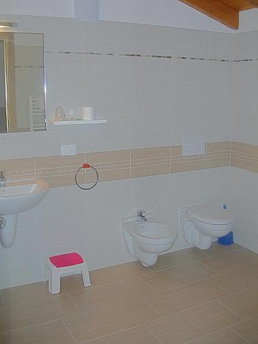 a bathroom with two sinks and two toilets at Al Cavaliere in Pordenone