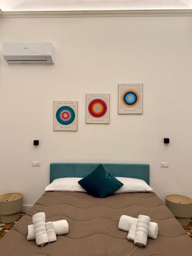 a bedroom with a bed with two towels on it at Palermo Central Rooms in Palermo