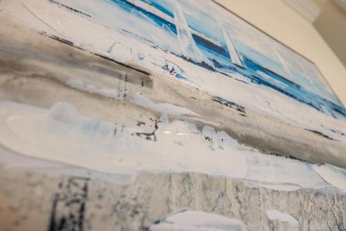 a painting with blue and white paint on a wall at Ocean View l Pet Friendly in Gilchrist
