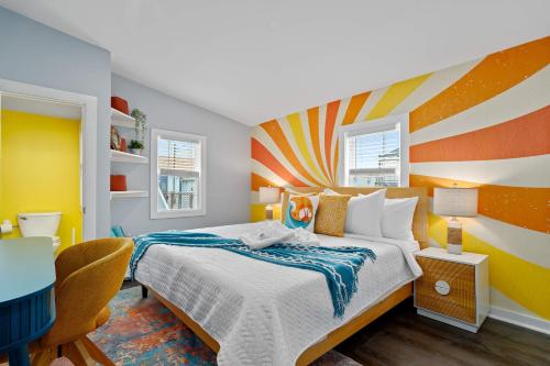 a bedroom with a bed with a colorful accent wall at Salisbury Surf Pet Friendly 1 Block to Beach in Salisbury