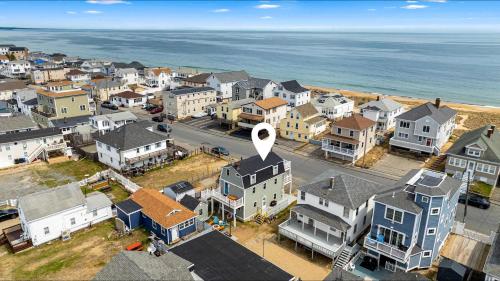 an aerial view of a town with houses and the ocean at Salisbury Surf Pet Friendly 1 Block to Beach in Salisbury