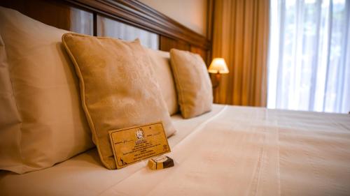 a wooden box sitting on top of a bed at Hotel Gramado Interlaken in Gramado