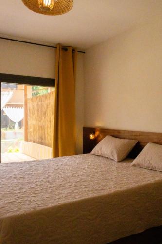 a bedroom with a large bed with a window at Sama Lodge in Saly Portudal
