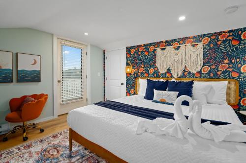 a bedroom with a large bed and a orange chair at Salisbury Sol Pet Friendly Private Balconies in Salisbury