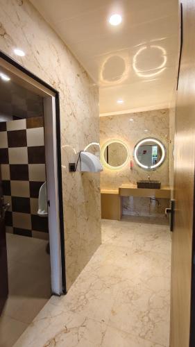 a bathroom with a sink and two mirrors at The Z Retreat & Spa - Swimming Pool & Free Parking - Near Tashi ViewPoint in Gangtok